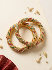 Pink, green and blue Jadau bangles with pearl-style accents and gold-plated detailing, designed for weddings, mehendi and festive celebrations.
