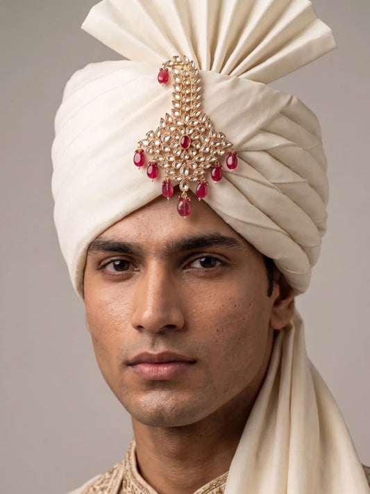 Groom wearing a red Designer Kundan Safa Kalgi styled on a traditional wedding turban