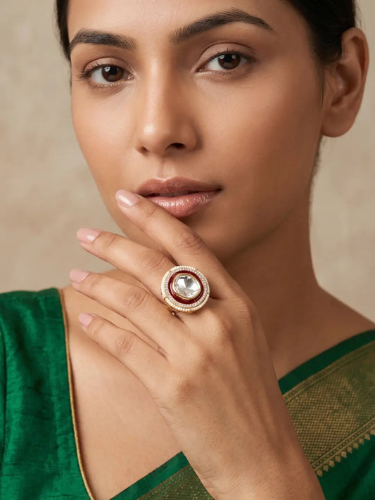 Red enamel Polki statement ring with a large faceted centre stone, sparkling CZ accents, pearl border and warm gold plated finish for wedding looks