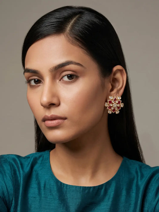 Red floral Kundan stud earrings with petal-shaped clear stones, enamel detailing and sparkling center in a gold-toned finish