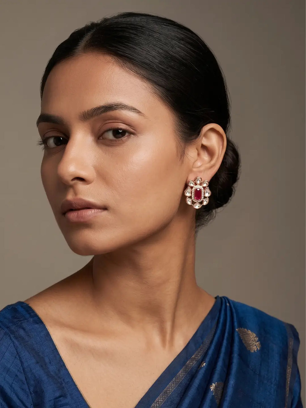 Red floral Kundan stud earrings with oval coloured centre stone, clear CZ stones and gold plated detailing for Indian festive jewellery