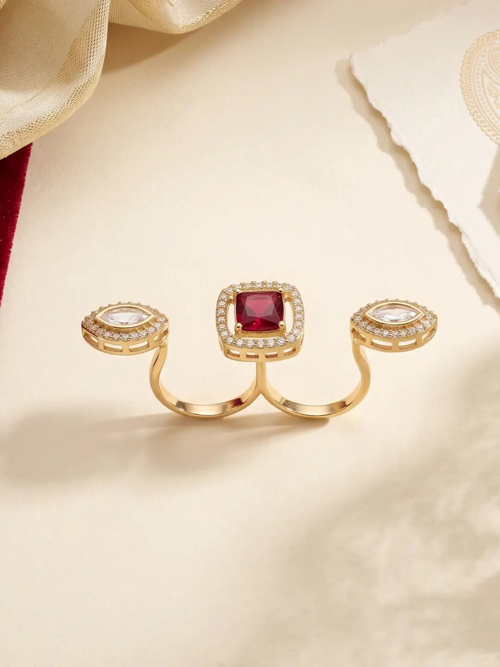 Red gold plated square Polki double finger ring with marquise-shaped CZ motifs, styled as a statement accessory for bridal and wedding outfits.