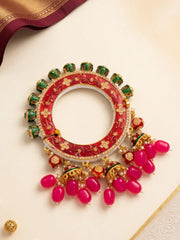 Red Meenakari Kundan Pacheli kada with floral motifs, pearl accents and jhumka details, styled as a statement bangle for ethnic outfits.