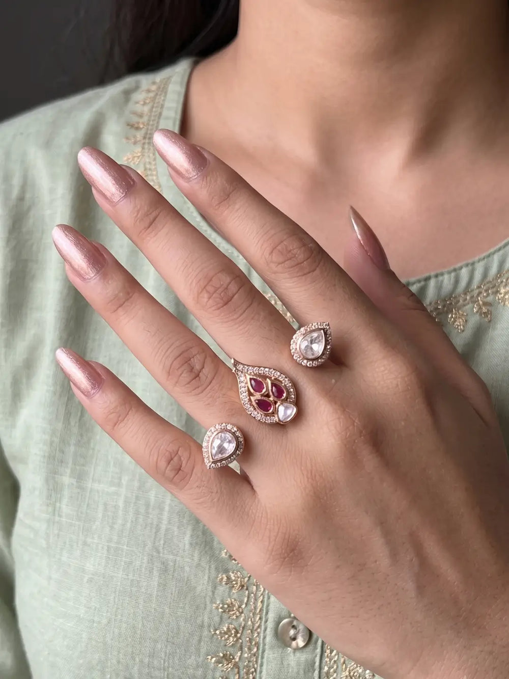 Ruby pink gold plated double finger ring with CZ, Polki-style and colourful stones, designed for party wear, bridal and festive looks.