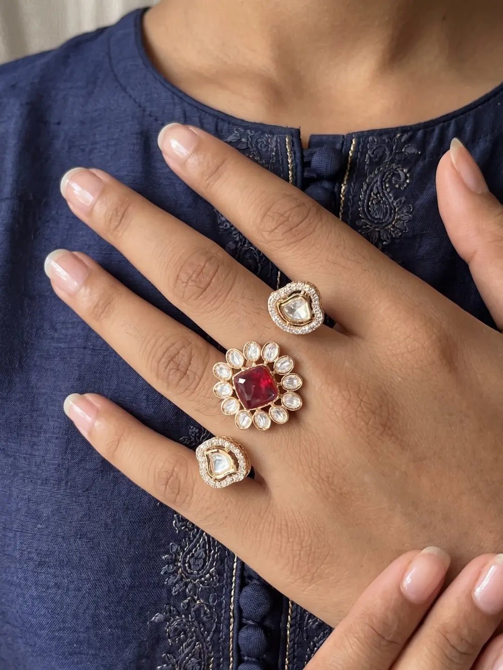 Ruby pink Kundan Polki and CZ double finger ring with gold plating, featuring a floral design for bridal, wedding and festive looks.