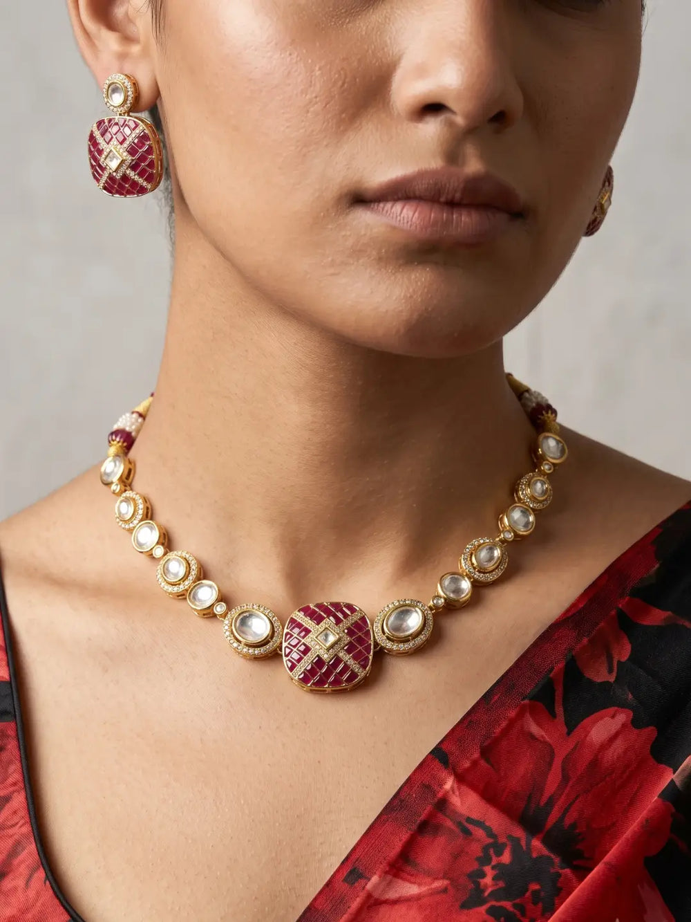 Ruby pink Kundan Polki necklace set with CZ stones, red enamel detailing and matching earrings, designed for weddings and festive occasions.