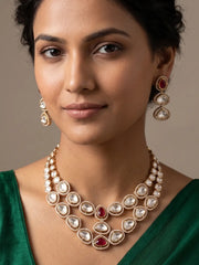 Ruby and Polki double layer necklace set with oval and teardrop stones, gold-tone framing and matching earrings for bridal and festive occasions