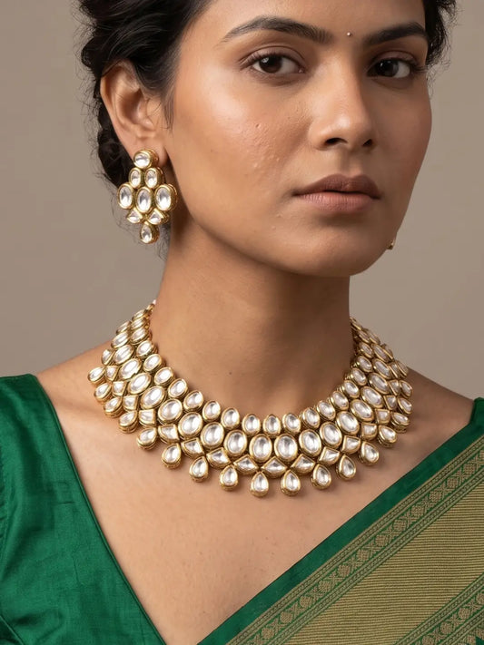 Traditional gold plated Kundan choker necklace set with clustered white stones, ornate gold-tone settings and matching earrings for bridal wedding wear