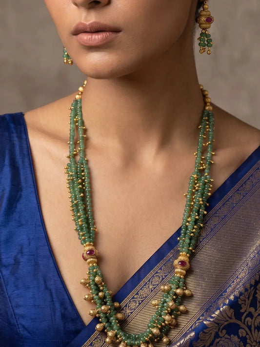 Traditional long green beaded jewellery set with layered jade beads, gold ghungroo accents and matching earrings for ethnic celebrations