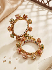 Traditional Meenakari Kundan Gokhru kada bangles with pearl accents, red and green detailing and gold plating for bridal and wedding outfits.