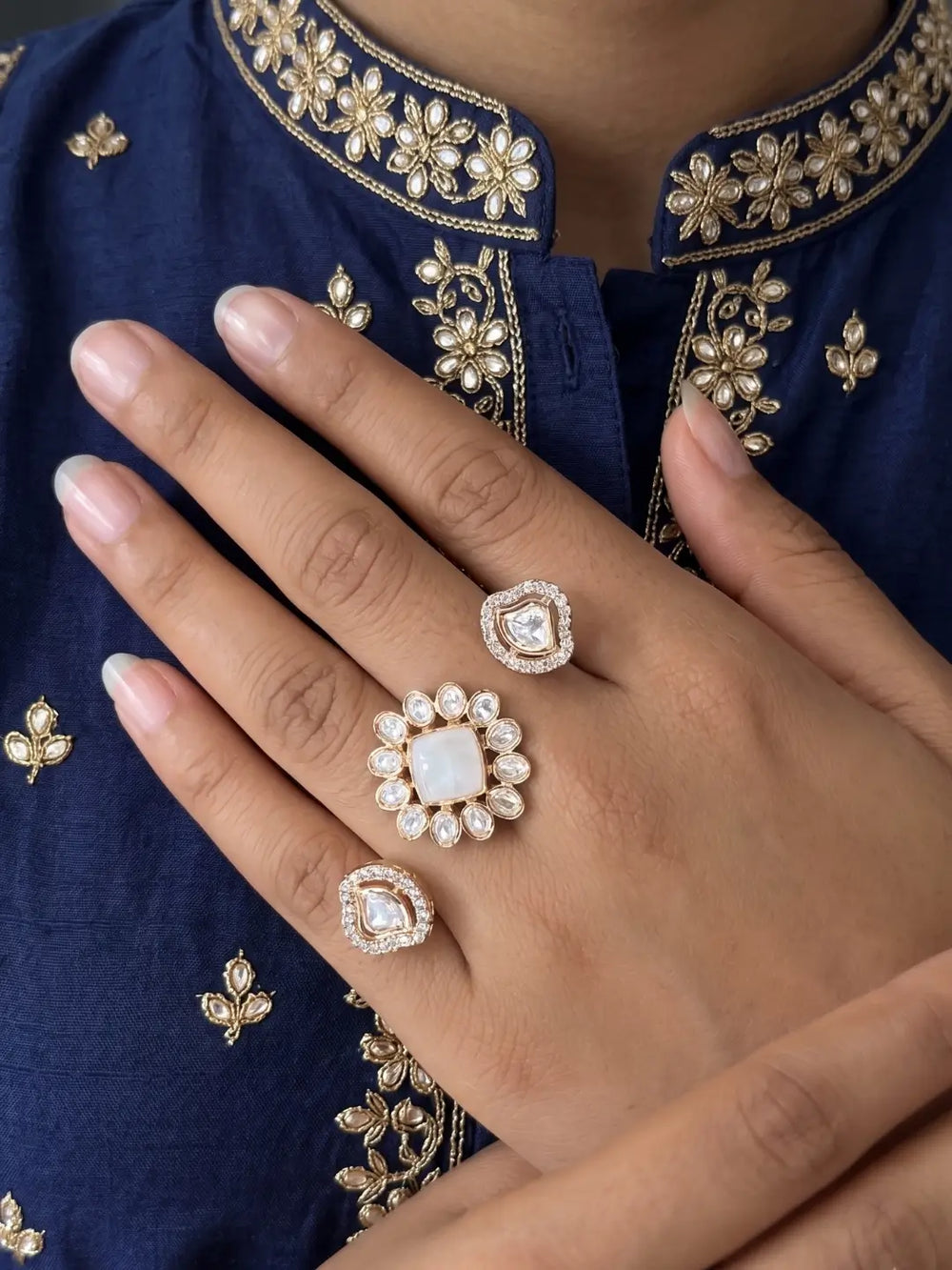 White Kundan Polki and CZ double finger ring with gold plating, featuring a floral design for bridal, wedding and festive occasions.