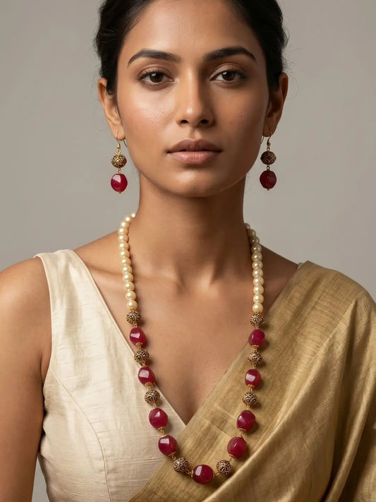 Woman Wearing Long Natural Red Jade Beaded Mala with Faux Pearls and Gold-Tone Accents