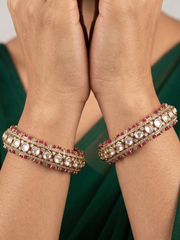 a close up image of a women hands wearing Designer Antique Victorian Polki Kundan Kada Bangles With Ruby Stones | Wedding & Bridal Bangles