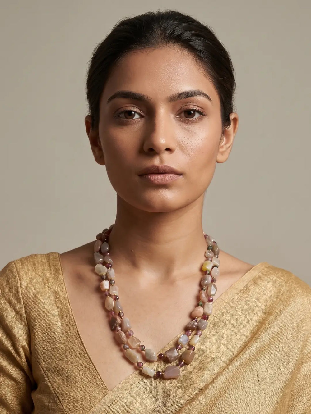 A women wearing a natural moonstone beaded mala on a golden saree