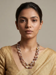 A women wearing a natural moonstone beaded mala on a golden saree