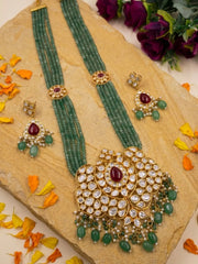 Close view of the large traditional pendant surrounded by sparkling polki and ruby stones, with a luxurious arrangement of dangling pearl drops