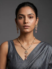 a women in agray saree is wearing an elegant gold-plated Kundan pendant necklace set with pink drop pendant and matching earrings, handcrafted traditional Indian jewellery for weddings, festive occasions, party wear, and ethnic outfits.