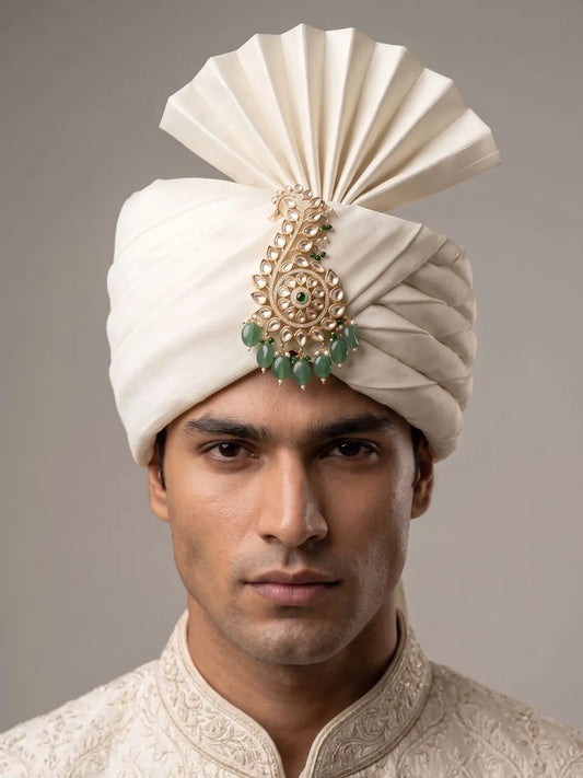 Green Kalangi pinned to pagdi, styled for royal Rajputi wedding function.