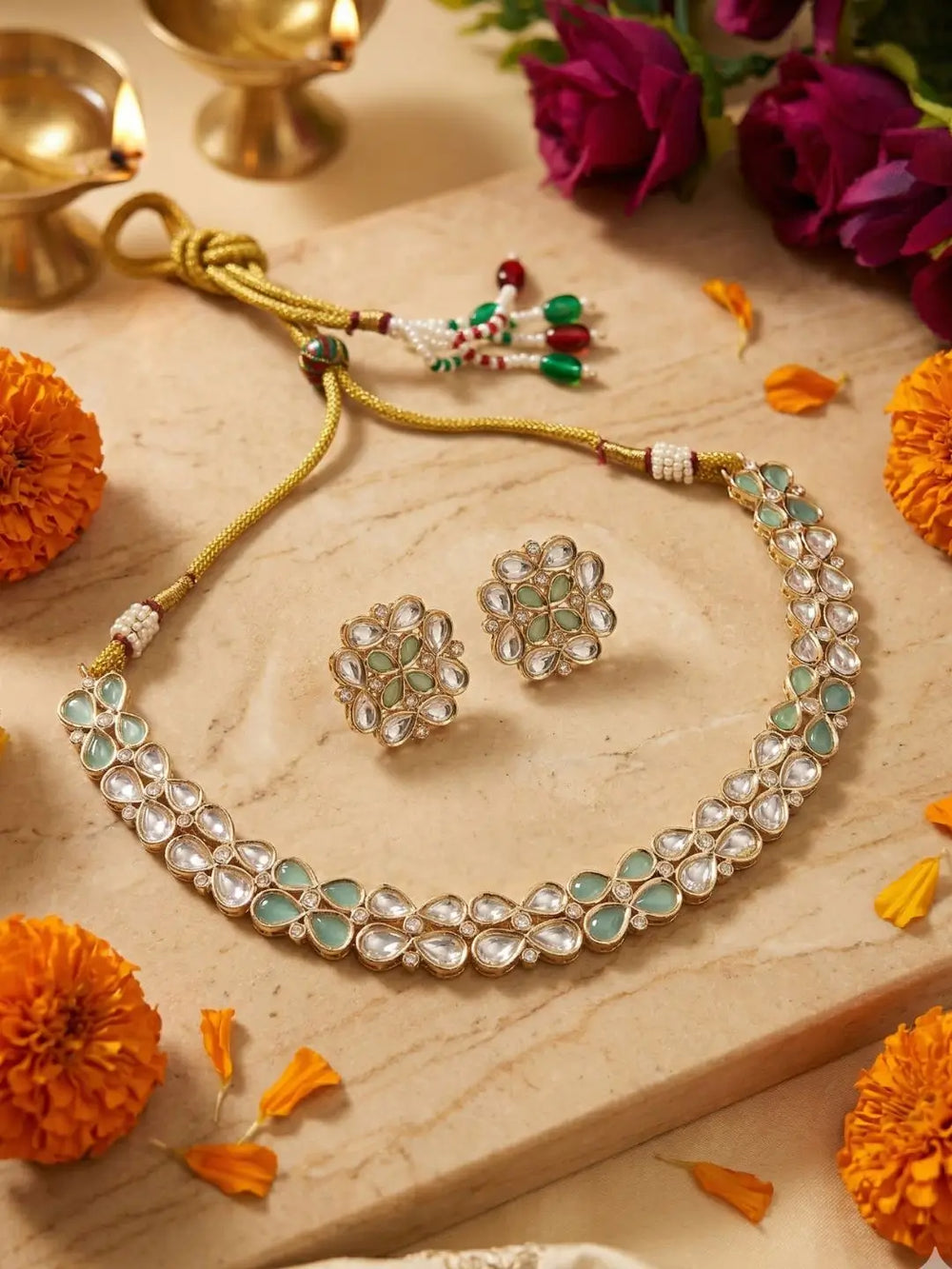 Kundan Jewelry set with necklace and earrings on a wooden surface with flowers around