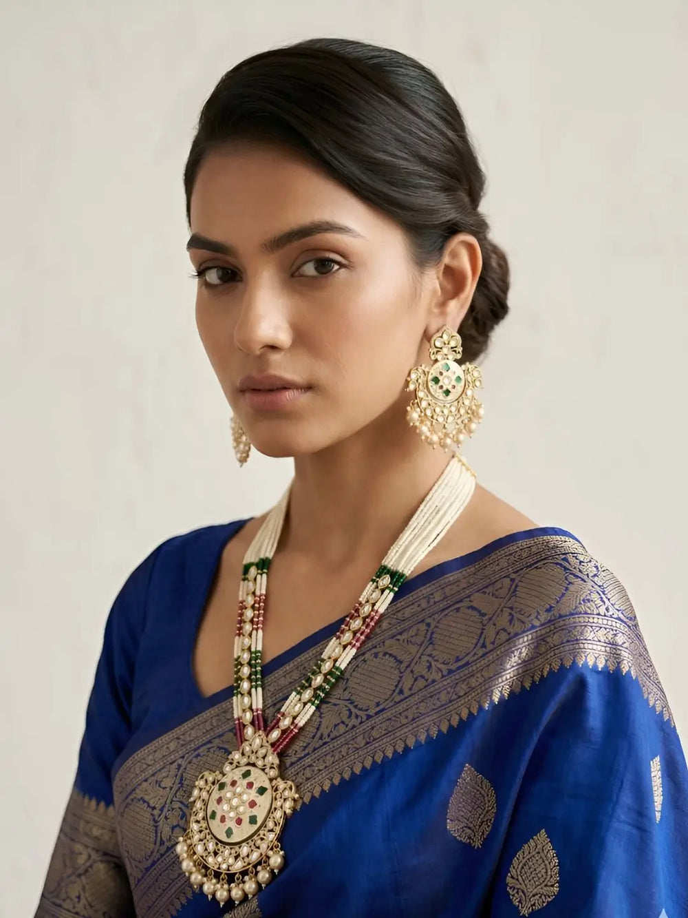 a women wearing a Traditional Long Pearls Beaded Kundan Necklace Set With red and green Enamel | Wedding Jewellery Set