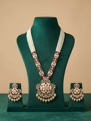 Jewelry set with necklace and earrings on a green mannequin against a beige background