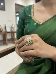 a lady wearing a square shaped kundan ring on her finger