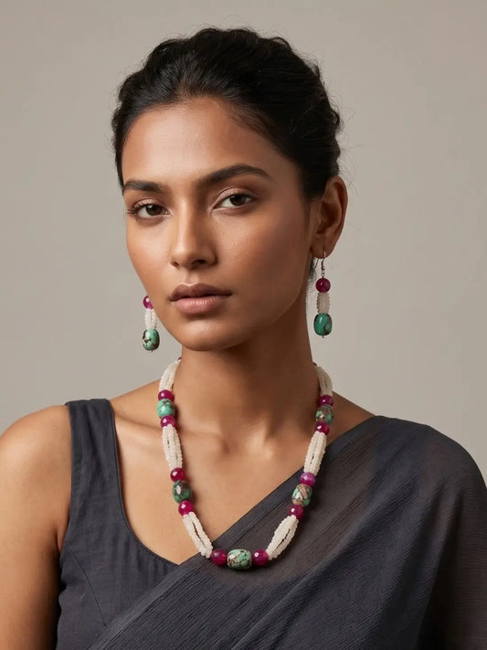 Handcrafted White Rainbow Moonstone faceted beads necklace with natural Turquoise oval beads, Pink Onyx gemstones, and matching earrings worn by a women