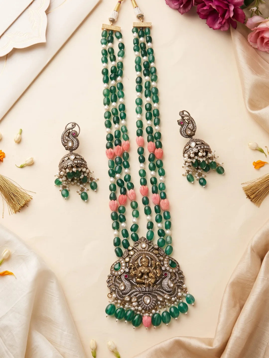 Green Lakshmi necklace set featuring a detailed Goddess pendant, Kundan and Polki stonework, layered beads and matching traditional earrings.