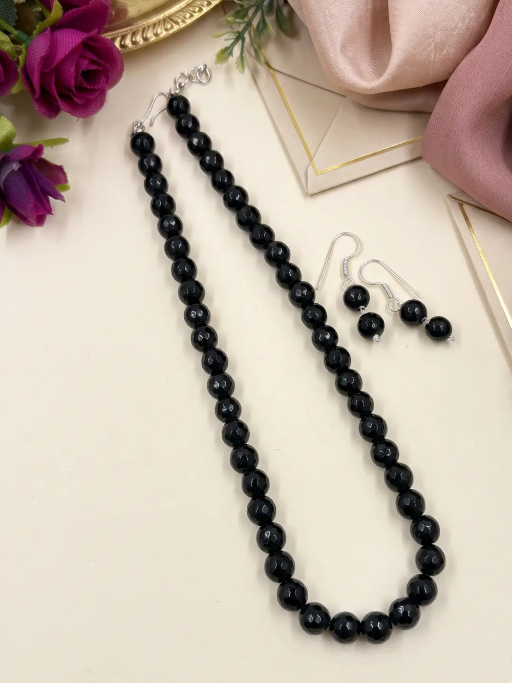 Single-strand black faceted round jade bead mala necklace shown with matching drop earrings and silver-tone accents