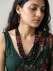 Pair of drop earrings made with black and red beads on silver-plated fish hook wires, shown as the matching earrings of the beaded necklace set