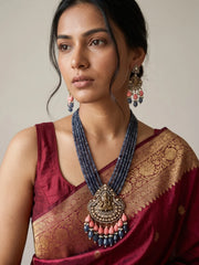 Blue Ganesha temple necklace set featuring an ornate Ganpati pendant, antique-style detailing, layered jade beads and matching traditional earrings.