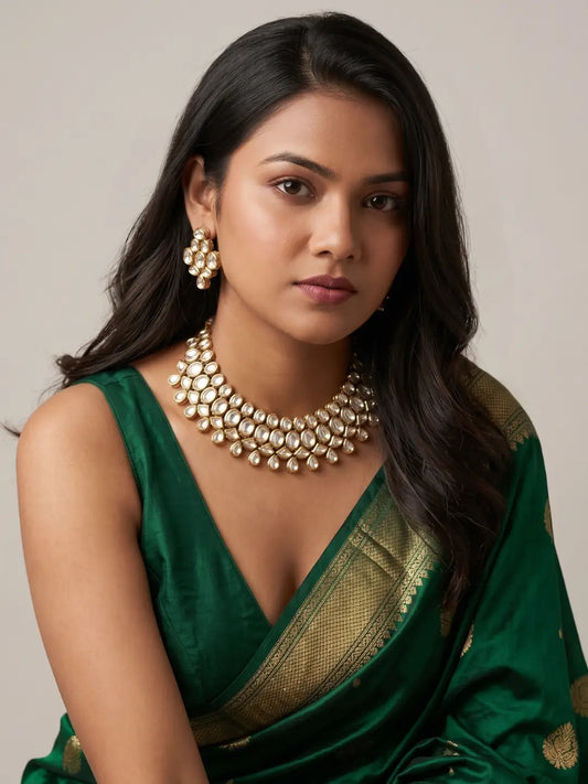 Broad Kundan choker necklace featuring closely arranged oval and teardrop white stones in gold-tone settings for sarees, lehengas and festive looks