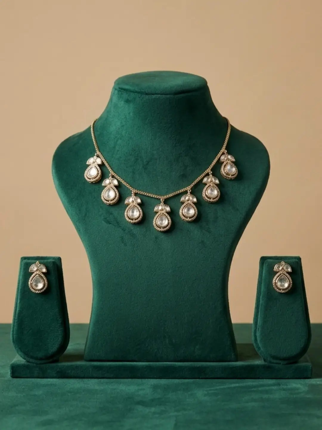 Gold-tone Polki chain necklace set with teardrop motifs and matching earrings, styled for sarees, kurtas, lehengas, cocktail dresses and Western outfits.