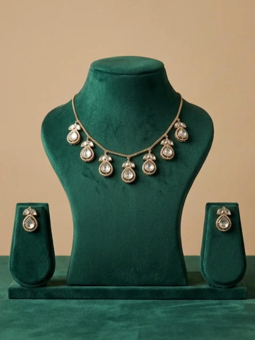 Gold-tone Polki chain necklace set with teardrop motifs and matching earrings, styled for sarees, kurtas, lehengas, cocktail dresses and Western outfits.