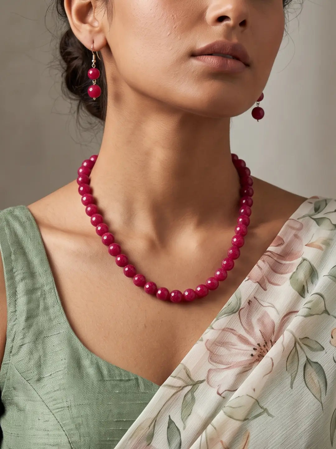 Single-strand cherry-red faceted round bead mala necklace shown with matching drop earrings and silver-tone accents