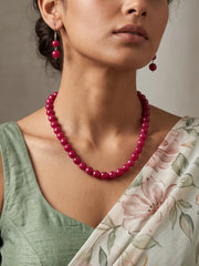 Single-strand cherry-red faceted round bead mala necklace shown with matching drop earrings and silver-tone accents