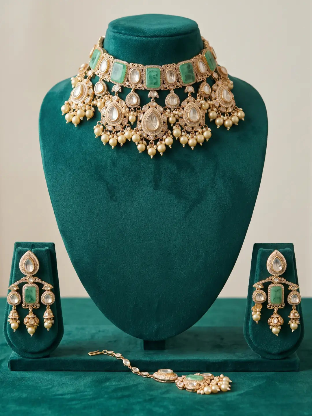 Full mint green bridal jewellery set displaying the statement choker necklace, matching earrings and maang tikka with rectangular green stones and pearl drops.