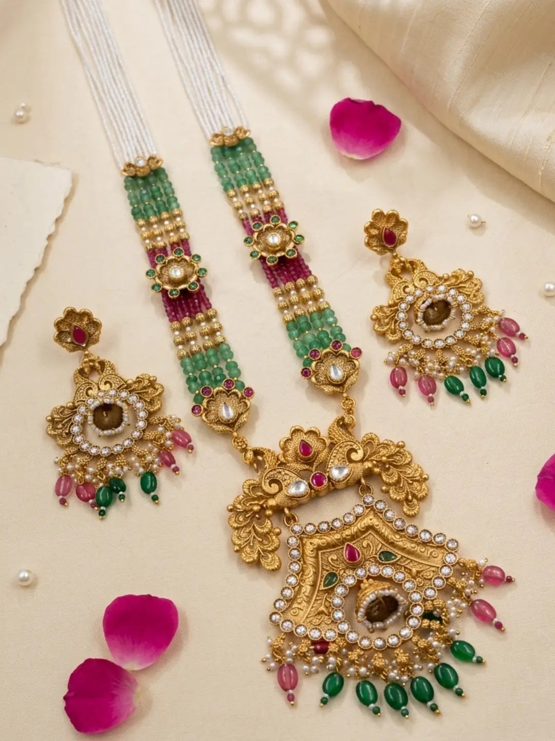 Full antique gold necklace set with a statement floral pendant and matching earrings, featuring green and maroon jade beads, Kundan stones and CZ accents.