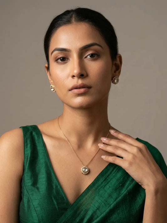 Delicate gold-plated chain necklace featuring a round Polki pendant with Kundan and CZ stones, paired with matching stud earrings