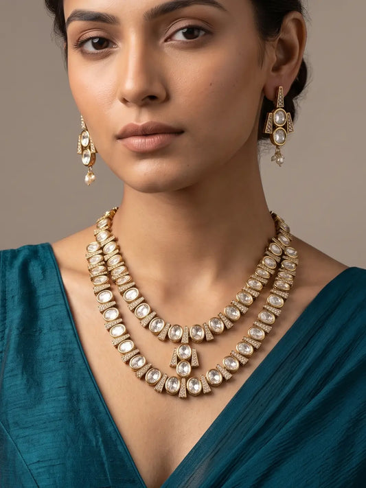 Double layer Polki necklace set featuring oval white stones, intricate gold-tone detailing and matching drop earrings for weddings and festive occasions