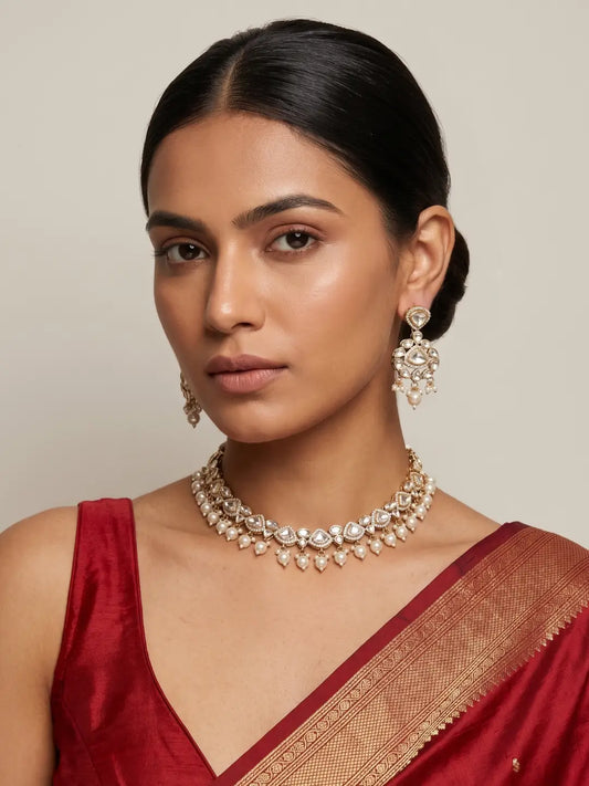 Elegant Kundan Polki necklace featuring luminous teardrop-shaped stones, gold-tone detailing and graceful pearl drops.