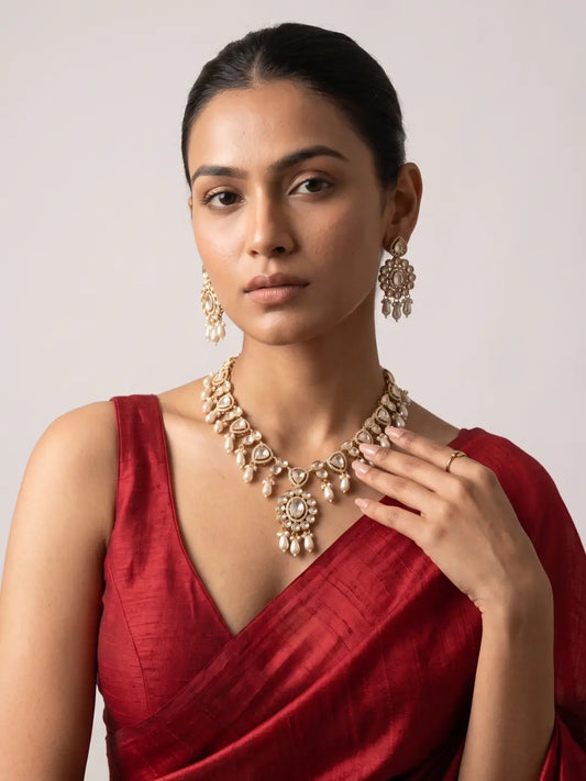 Elegant Polki necklace featuring luminous teardrop-shaped stones, gold-tone detailing and multiple graceful faux pearl drops.
