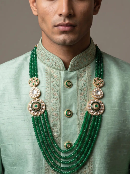 Emerald green beaded sherwani mala for groom with jade beads, Kundan Polki brooches and gold-plated details for Indian wedding styling.