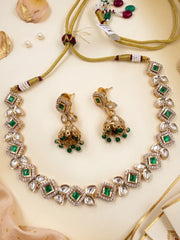 Emerald green Kundan choker set with matching Jhumka earrings, white Polki stones and intricate gold-tone detailing