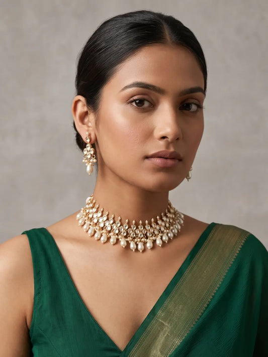 Traditional Kundan Polki choker featuring luminous stones, gold-tone detailing and multiple faux pearl drops along the lower edge.