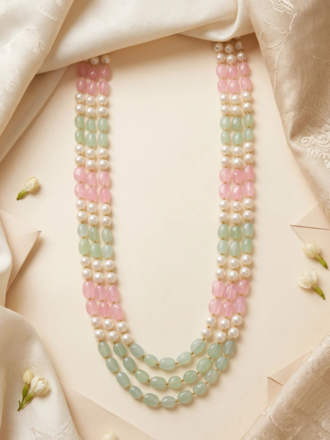 Pastel groom mala combining pink and mint green jade beads, white faux pearls and gold-tone accents, designed to complement embroidered sherwanis and achkans.