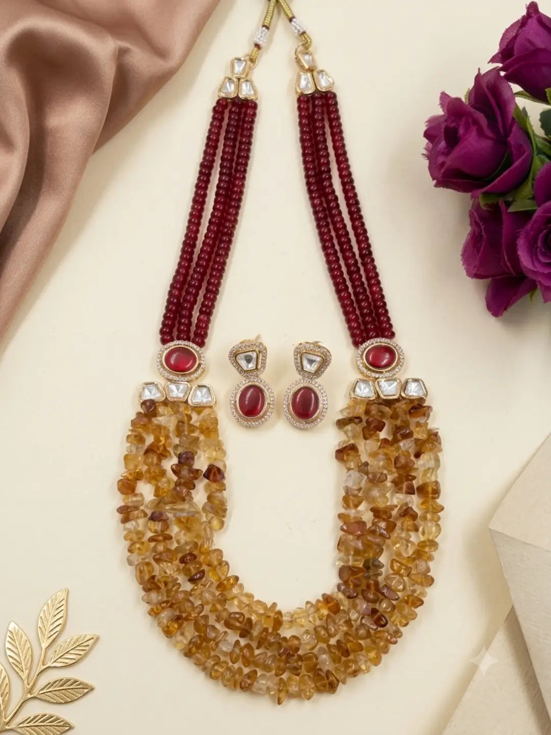 Ethnic red jade and citrine beaded jewellery set with layered strands and matching earrings for festive and traditional Indian outfits.
