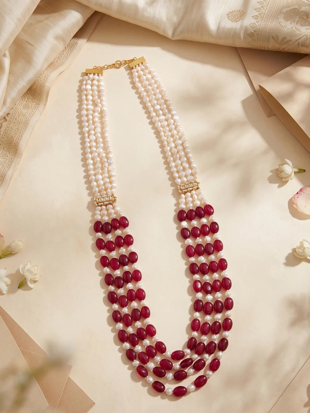 Traditional men's sherwani mala featuring ruby red jade beads, freshwater pearls and gold-tone decorative accents, creating a distinctive groom wedding look.