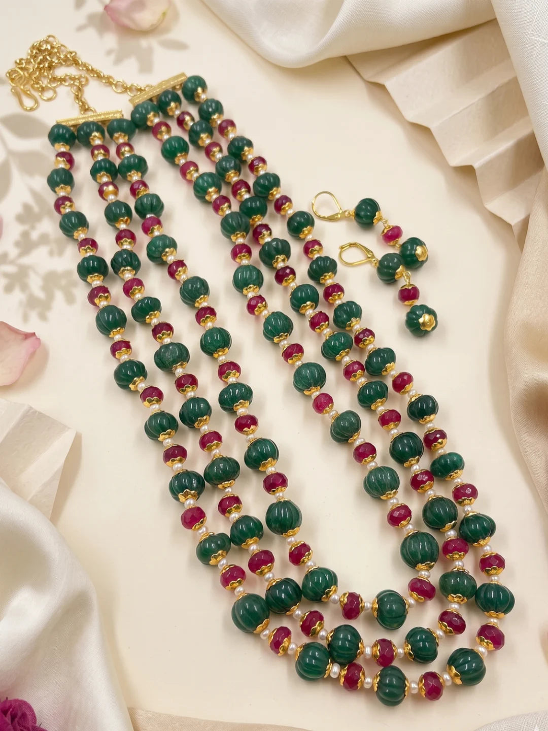 Ethnic ruby red and green jade beaded necklace set with layered strands and matching earrings for festive and traditional occasions.