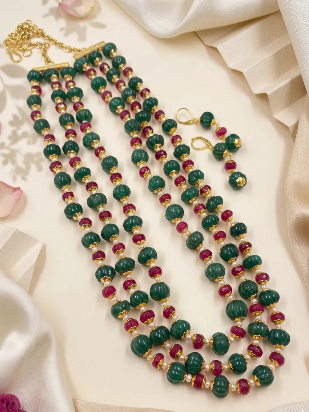 Ethnic ruby red and green jade beaded necklace set with layered strands and matching earrings for festive and traditional occasions.
